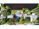 Aerial view displaying the backyard's waterfront access, bordered by mature trees and green space at 1163 60Th S Ave, St Petersburg, FL 33705