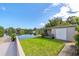 Scenic backyard featuring a lush lawn, patio, and serene lake view, ideal for outdoor enjoyment at 1163 60Th S Ave, St Petersburg, FL 33705