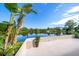 Lush backyard features a tranquil lake view and tropical landscaping, creating a serene atmosphere at 1163 60Th S Ave, St Petersburg, FL 33705