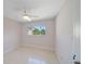 Bedroom with neutral walls, a ceiling fan, and a window offering a beautiful outdoor view at 1163 60Th S Ave, St Petersburg, FL 33705