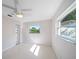 Bedroom with water view, terrazzo flooring, ceiling fan, and mirrored closet at 1163 60Th S Ave, St Petersburg, FL 33705