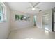 Spacious bedroom with terrazzo floors and a large window overlooking lush greenery at 1163 60Th S Ave, St Petersburg, FL 33705
