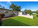 Charming home exterior featuring lush green lawn and inviting patio area with beautiful landscaping at 1163 60Th S Ave, St Petersburg, FL 33705