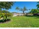 Charming single story home with a well-manicured lawn and several palm trees in the front yard at 1163 60Th S Ave, St Petersburg, FL 33705