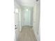 Bright hallway featuring neutral tile floors and white doors for a clean, modern aesthetic at 1163 60Th S Ave, St Petersburg, FL 33705