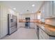 Updated kitchen with stainless steel appliances, granite countertops, and ample cabinet space at 1163 60Th S Ave, St Petersburg, FL 33705