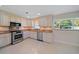 Well-lit kitchen featuring stainless steel appliances, granite counters, and plenty of cabinetry at 1163 60Th S Ave, St Petersburg, FL 33705