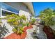 Landscaped side yard showing an artistic walkway with rocks and mulch leading to the backyard at 1163 60Th S Ave, St Petersburg, FL 33705