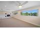 Bright and spacious living room with large windows, lake views, and a cozy fireplace at 1163 60Th S Ave, St Petersburg, FL 33705