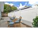 Inviting backyard patio area with wicker furniture, blue cushions, and a privacy fence at 1260 S Hillcrest Ave, Clearwater, FL 33756