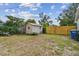 Spacious backyard with a storage shed, a wooden fence, and a trash receptacle at 1260 S Hillcrest Ave, Clearwater, FL 33756