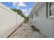 View of the backyard with a fenced-in patio, gray exterior, and a view of the sunny sky at 1260 S Hillcrest Ave, Clearwater, FL 33756