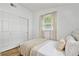 Comfortable bedroom with a queen bed, closet, and plenty of natural light at 1260 S Hillcrest Ave, Clearwater, FL 33756
