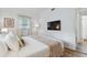 Comfortable bedroom features a queen bed, flat screen television, and hardwood floors at 1260 S Hillcrest Ave, Clearwater, FL 33756
