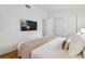 Bedroom view featuring a television, storage closet, and comfortable queen bed at 1260 S Hillcrest Ave, Clearwater, FL 33756
