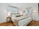 Bright bedroom with a queen size bed, stylish side tables, and hardwood floors at 1260 S Hillcrest Ave, Clearwater, FL 33756