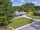 Aerial view of cozy home with lush greenery, long driveway, and fenced yard at 1260 S Hillcrest Ave, Clearwater, FL 33756