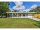 Charming single-story home with a well-manicured lawn, a covered front porch, and an attached garage at 1260 S Hillcrest Ave, Clearwater, FL 33756