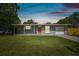 Charming single-story home featuring a well-maintained lawn and bright orange front door at 1260 S Hillcrest Ave, Clearwater, FL 33756