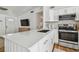 Bright kitchen features a large quartz island, stainless steel appliances, and gold fixtures at 1260 S Hillcrest Ave, Clearwater, FL 33756