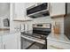 Clean kitchen design with stainless steel appliances, subway tile backsplash, and ample cabinet space at 1260 S Hillcrest Ave, Clearwater, FL 33756