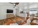 Bright and airy living room with hardwood floors, a ceiling fan, and a clear view into the kitchen at 1260 S Hillcrest Ave, Clearwater, FL 33756