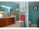 Well-lit bathroom featuring a glass shower, wooden cabinets, and blue walls at 1308 Crystal Greens Dr, Sun City Center, FL 33573