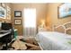 Cozy bedroom with work station, desk, bed with natural light from window and neutral walls at 1308 Crystal Greens Dr, Sun City Center, FL 33573