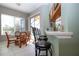 Open-concept kitchen featuring a breakfast nook with bar seating and a view of the screened-in pool area at 1308 Crystal Greens Dr, Sun City Center, FL 33573