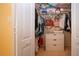 Well-organized walk-in closet with ample shelving, drawers, and hanging space for storage at 1308 Crystal Greens Dr, Sun City Center, FL 33573