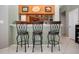 Bright dining area with breakfast bar and modern stools, open to kitchen at 1308 Crystal Greens Dr, Sun City Center, FL 33573