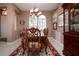 Elegant dining room with wooden furniture, chandelier, and decorative accents, ideal for hosting guests at 1308 Crystal Greens Dr, Sun City Center, FL 33573