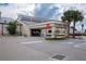 Exterior view of the fitness center featuring a covered entrance and ample parking at 1308 Crystal Greens Dr, Sun City Center, FL 33573