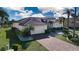 Inviting single-story home boasts well-maintained landscaping and a paver driveway at 1308 Crystal Greens Dr, Sun City Center, FL 33573