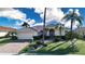 Charming single-story home featuring lush landscaping, a brick driveway and a neutral color palette at 1308 Crystal Greens Dr, Sun City Center, FL 33573