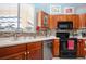 Kitchen with wood cabinets, stainless steel appliances, mosaic backsplash, and plenty of counter space at 1308 Crystal Greens Dr, Sun City Center, FL 33573