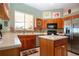 Bright kitchen featuring light countertops, wood cabinets, an island and stainless steel appliances at 1308 Crystal Greens Dr, Sun City Center, FL 33573