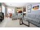 Open-concept living room with comfortable seating and views into the kitchen and outdoor dining area at 1308 Crystal Greens Dr, Sun City Center, FL 33573