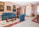 A living room with blue furniture and tile flooring, and access to a dining room at 1308 Crystal Greens Dr, Sun City Center, FL 33573