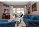 Inviting living room with comfortable blue furniture and sliding glass doors to the pool area at 1308 Crystal Greens Dr, Sun City Center, FL 33573