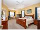 Inviting main bedroom with a tray ceiling, wood furnishings, and windows providing ample natural light at 1308 Crystal Greens Dr, Sun City Center, FL 33573