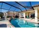 A view of the refreshing screened pool and patio area with an outdoor seating, and a backyard grill at 1308 Crystal Greens Dr, Sun City Center, FL 33573