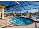 Gorgeous screened-in pool with a water feature overlooking the lake, including accessibility handrail at 1308 Crystal Greens Dr, Sun City Center, FL 33573