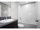 Bright bathroom includes a shower-tub combo, vanity with granite counters and ample lighting at 13355 Willow Bluestar Loop, Riverview, FL 33579
