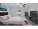 Cozy bedroom with a ceiling fan, natural light, and neutral tones create a serene and relaxing retreat at 13355 Willow Bluestar Loop, Riverview, FL 33579
