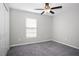 Neutral bedroom with a ceiling fan, closet, and window offering natural light at 13355 Willow Bluestar Loop, Riverview, FL 33579