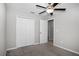 Carpeted bedroom featuring a ceiling fan, base trim, closet, and entry to hallway at 13355 Willow Bluestar Loop, Riverview, FL 33579