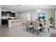 Well-lit dining area adjacent to modern kitchen with breakfast bar and stylish decor, promoting a warm and inviting space at 13355 Willow Bluestar Loop, Riverview, FL 33579