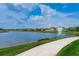 Picturesque pond view features a fountain and homes along the water, creating a serene setting at 13355 Willow Bluestar Loop, Riverview, FL 33579