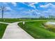 Scenic walking path winds through lush green space, offering a peaceful outdoor experience at 13355 Willow Bluestar Loop, Riverview, FL 33579